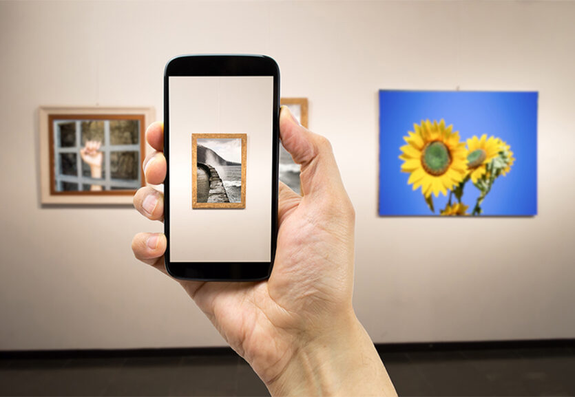 Person fotografiert mit dem Handy in einer Ausstellung